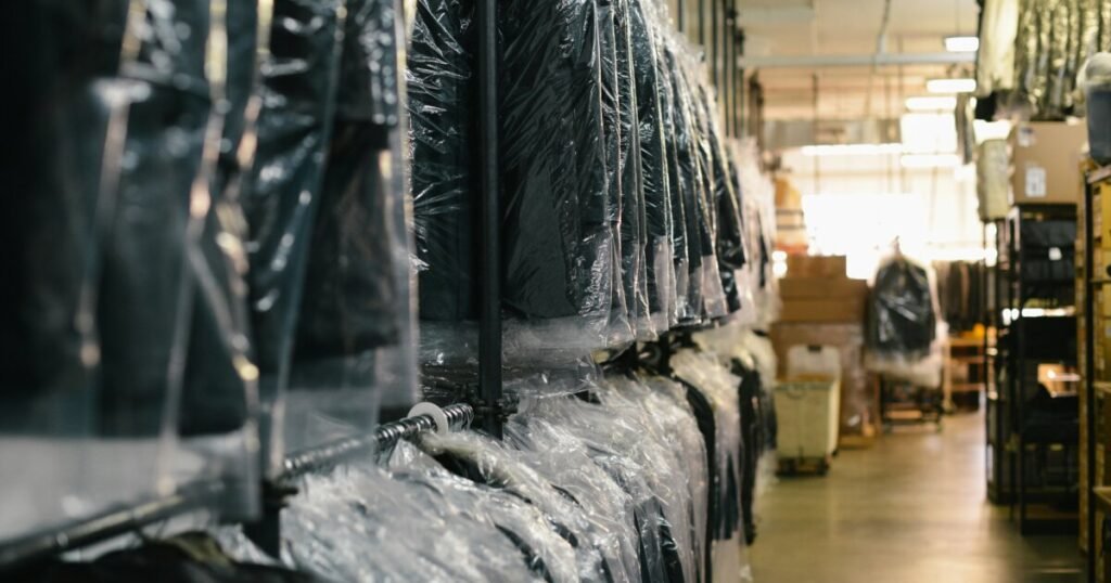 Freshly dry cleaned suit jackets hanging on a rack