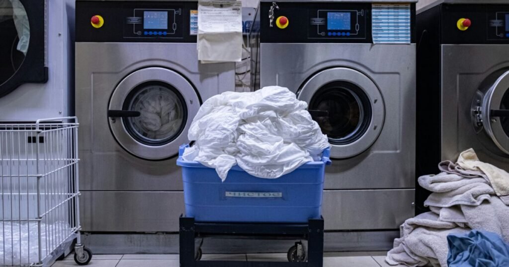 Laundry room with washing machine and basket ready for pickup