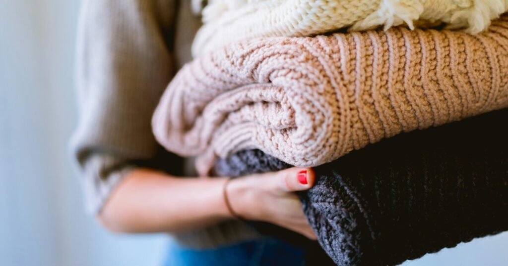 Person holding folded clean textiles